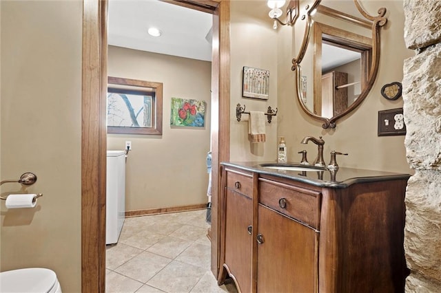 bathroom featuring tile patterned flooring, toilet, vanity, and baseboards