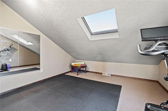 bonus room with lofted ceiling with skylight, visible vents, a textured ceiling, and carpet floors