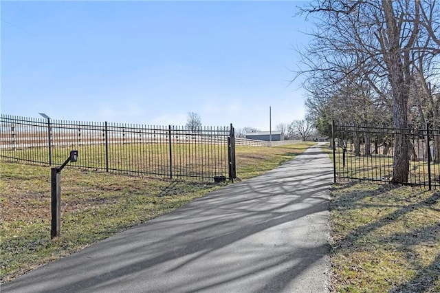 view of street featuring a gated entry and driveway