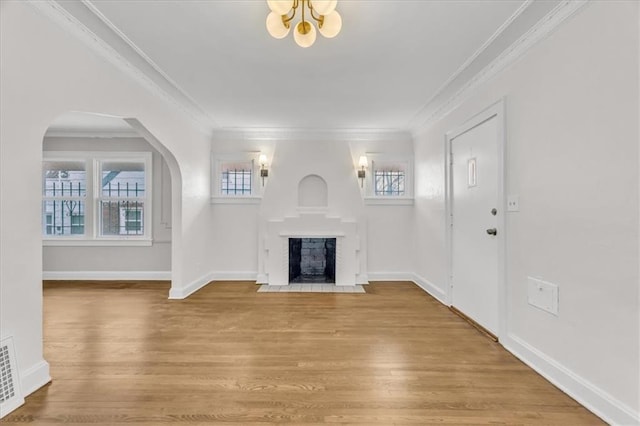 1122 E 76th St, Kansas City, MO 64131 - unfurnished living room featuring a fireplace with flush hearth, crown molding, wood finished floors, and baseboards