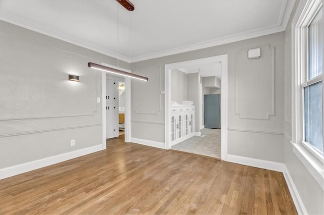 1122 E 76th St, Kansas City, MO 64131 - unfurnished room featuring light wood-style floors, baseboards, and crown molding