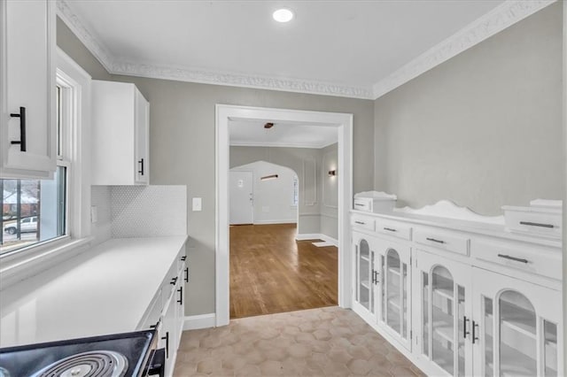 1122 E 76th St, Kansas City, MO 64131 - laundry area with baseboards, arched walkways, and crown molding