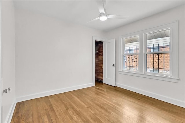 1122 E 76th St, Kansas City, MO 64131 - unfurnished room with ceiling fan, light wood-style flooring, and baseboards