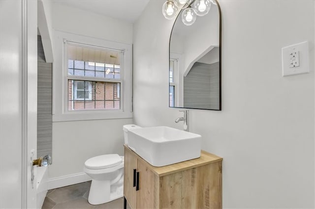 1122 E 76th St, Kansas City, MO 64131 - full bath featuring tile patterned flooring, baseboards, vanity, and toilet