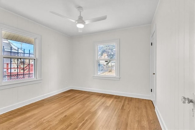 1122 E 76th St, Kansas City, MO 64131 - empty room featuring light wood finished floors, baseboards, and a ceiling fan