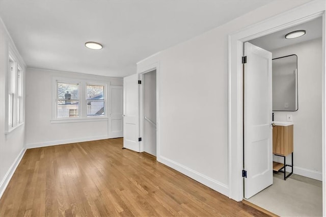 1122 E 76th St, Kansas City, MO 64131 - unfurnished bedroom with light wood-style flooring and baseboards