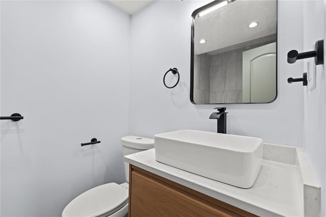 bathroom with toilet and vanity