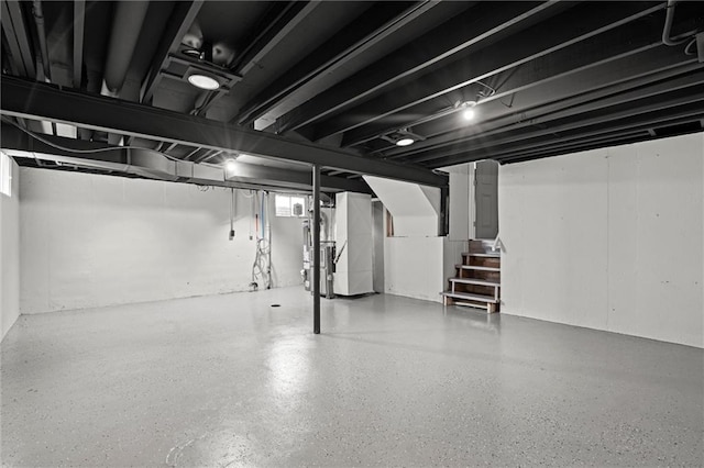 basement featuring heating unit and stairway