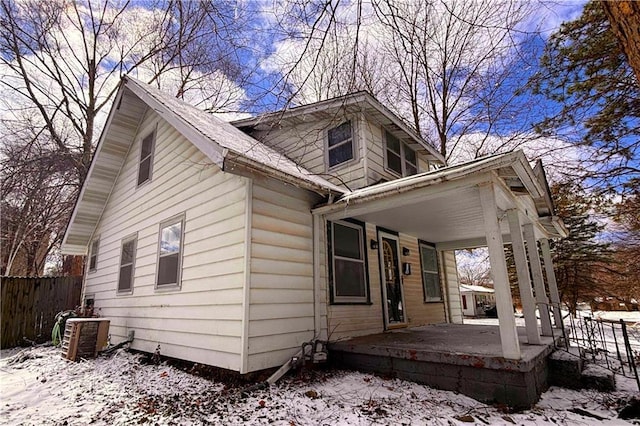 exterior space with cooling unit and fence