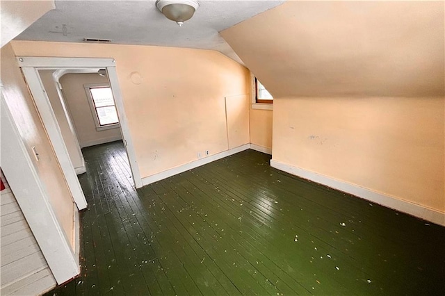 bonus room with lofted ceiling, a healthy amount of sunlight, and wood-type flooring