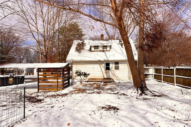 view of front of property with a chimney and fence