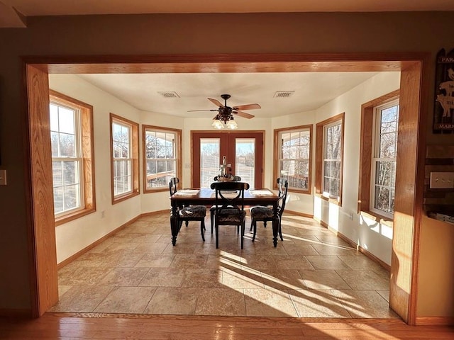 sunroom with visible vents, a ceiling fan, and french doors