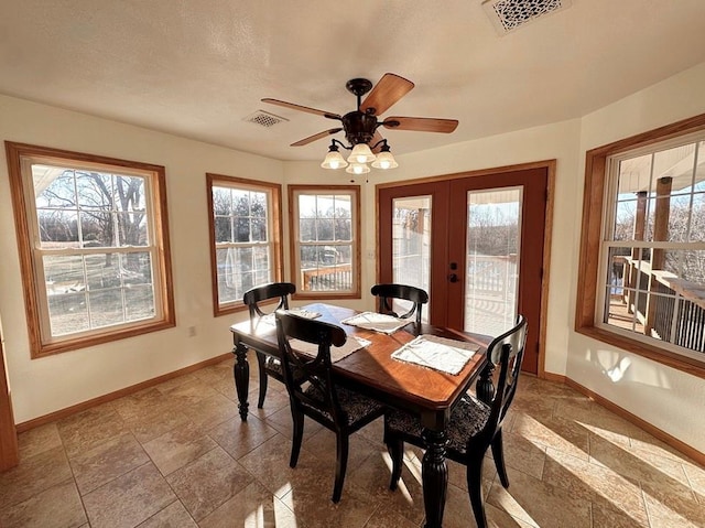 dining room with plenty of natural light, visible vents, and baseboards