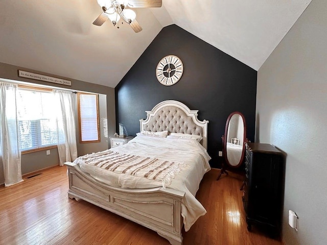 bedroom with lofted ceiling, ceiling fan, and wood finished floors