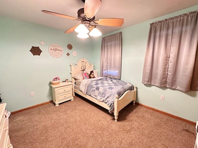 carpeted bedroom with ceiling fan and baseboards