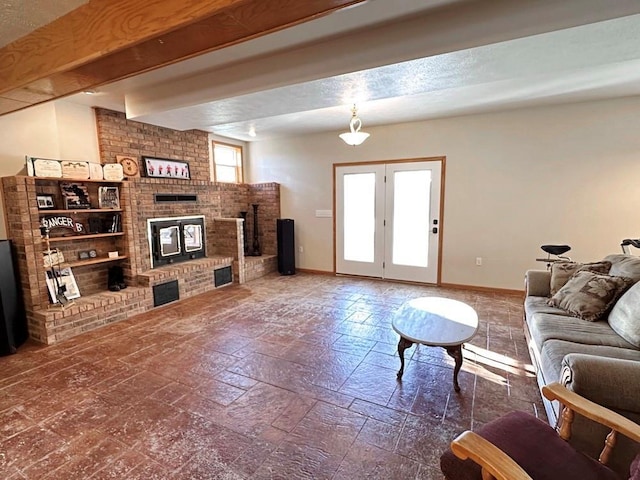 living area with beam ceiling, a brick fireplace, and baseboards