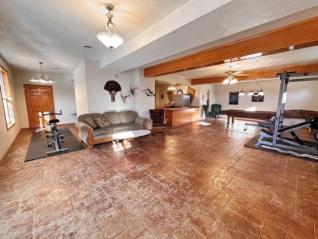 exercise area featuring stone finish floor, visible vents, and a ceiling fan