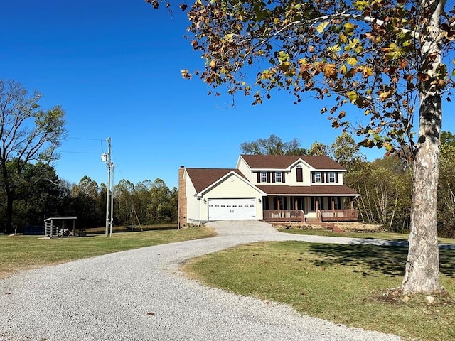 view of front of property featuring covered porch, a front lawn, gravel driveway, and an attached garage