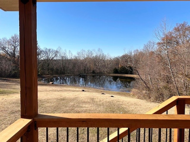 view of yard featuring a water view and a view of trees