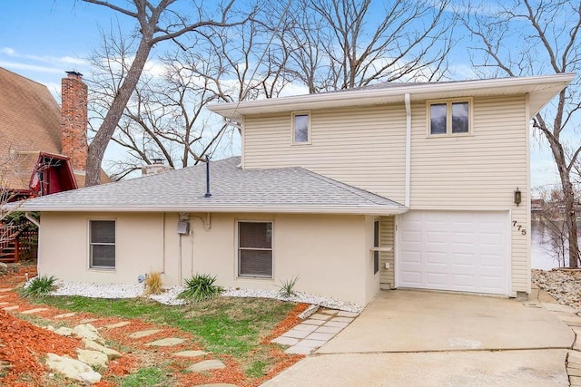 view of front facade featuring concrete driveway, roof with shingles, an attached garage, and stucco siding