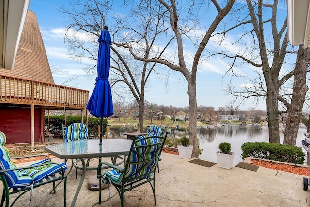 view of patio featuring outdoor dining space and a water view