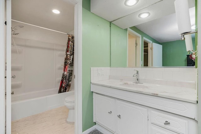 bathroom with shower / bath combo with shower curtain, vanity, toilet, and recessed lighting