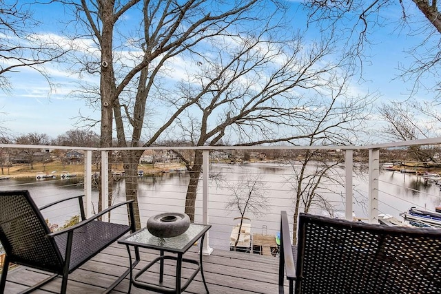 wooden terrace featuring a water view