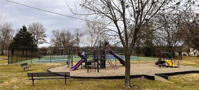 community jungle gym with a tennis court and fence