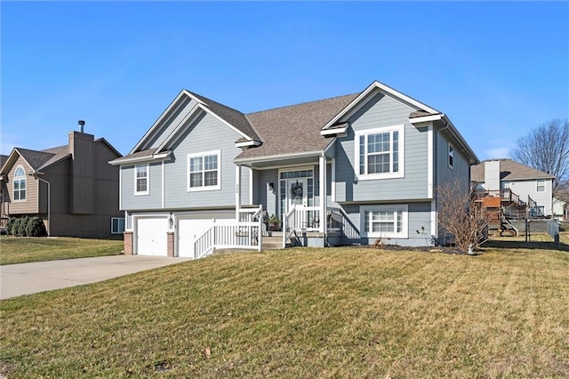 view of front of home featuring a garage, concrete driveway, and a front lawn