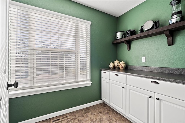 interior space featuring visible vents and baseboards