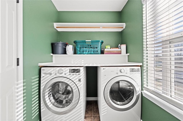 washroom featuring washing machine and clothes dryer, laundry area, and a healthy amount of sunlight