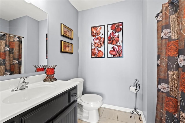 bathroom featuring vanity, a shower with shower curtain, baseboards, tile patterned floors, and toilet