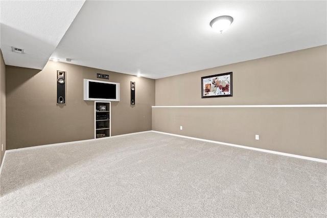 finished basement featuring visible vents, baseboards, and carpet floors