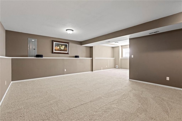 below grade area with visible vents, baseboards, and carpet floors