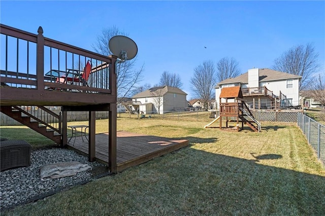 view of yard with a fenced backyard, stairway, a deck, and a playground