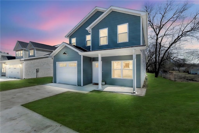 traditional-style home featuring a garage, covered porch, driveway, and a yard