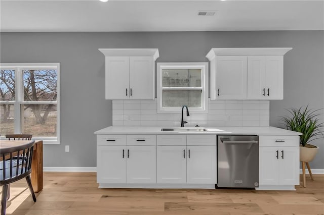 kitchen with visible vents, baseboards, dishwasher, and light countertops