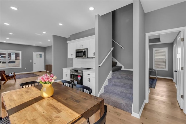 dining area featuring stairway, recessed lighting, light wood-style flooring, and baseboards