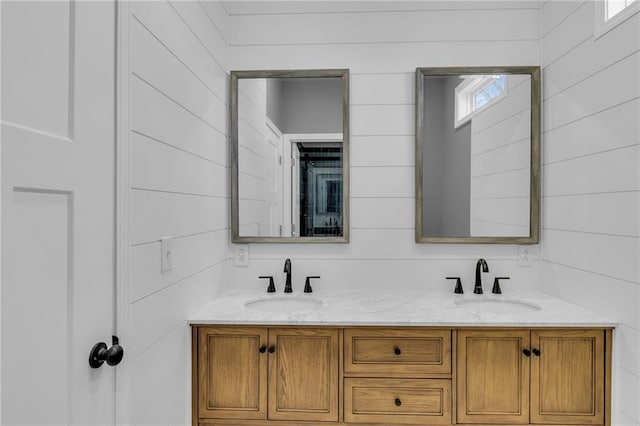 full bathroom with double vanity and a sink