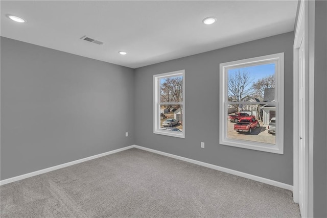 spare room with visible vents, recessed lighting, carpet, and baseboards