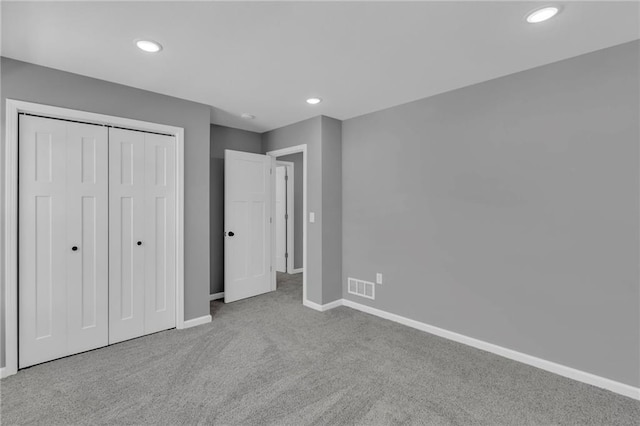 unfurnished bedroom with recessed lighting, carpet, visible vents, and baseboards