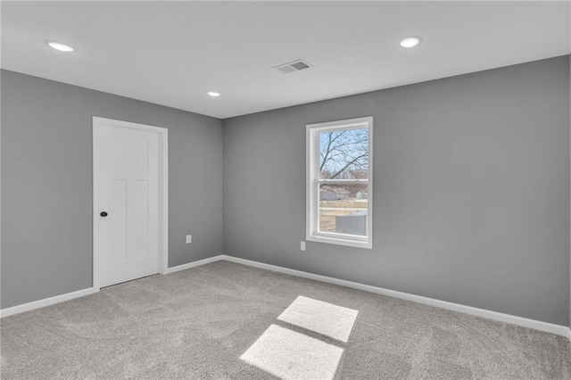 carpeted spare room with recessed lighting, visible vents, and baseboards