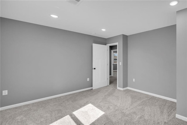 carpeted empty room with recessed lighting and baseboards