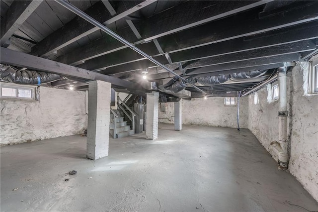 basement featuring stairs and plenty of natural light