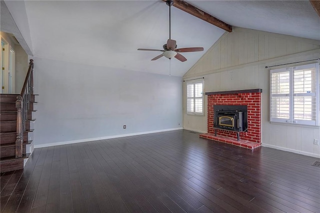 unfurnished living room with stairway, lofted ceiling with beams, a ceiling fan, baseboards, and hardwood / wood-style flooring