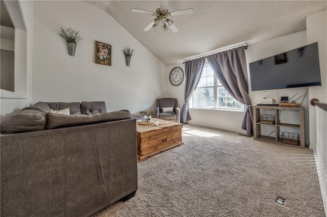 carpeted living area featuring lofted ceiling, a textured ceiling, and a ceiling fan