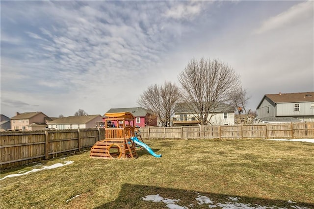 view of jungle gym featuring a residential view, a fenced backyard, and a yard