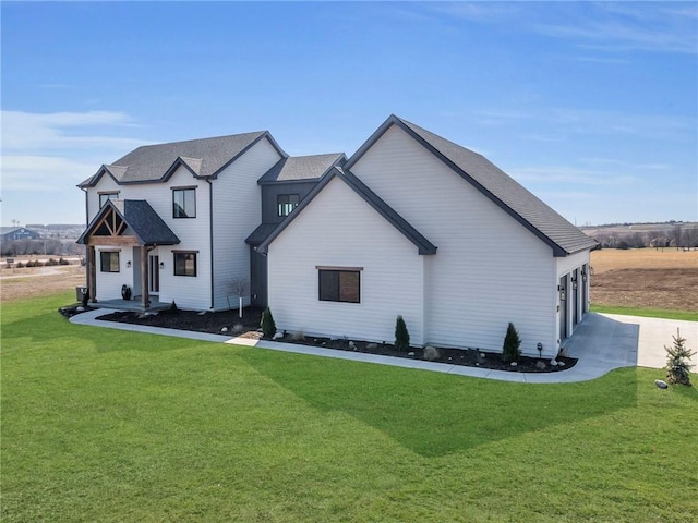 view of front of home with driveway, an attached garage, and a front lawn