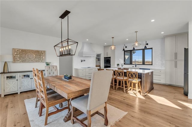 dining area with recessed lighting and light wood-style floors