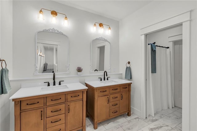 full bathroom with a shower with shower curtain, marble finish floor, two vanities, and a sink